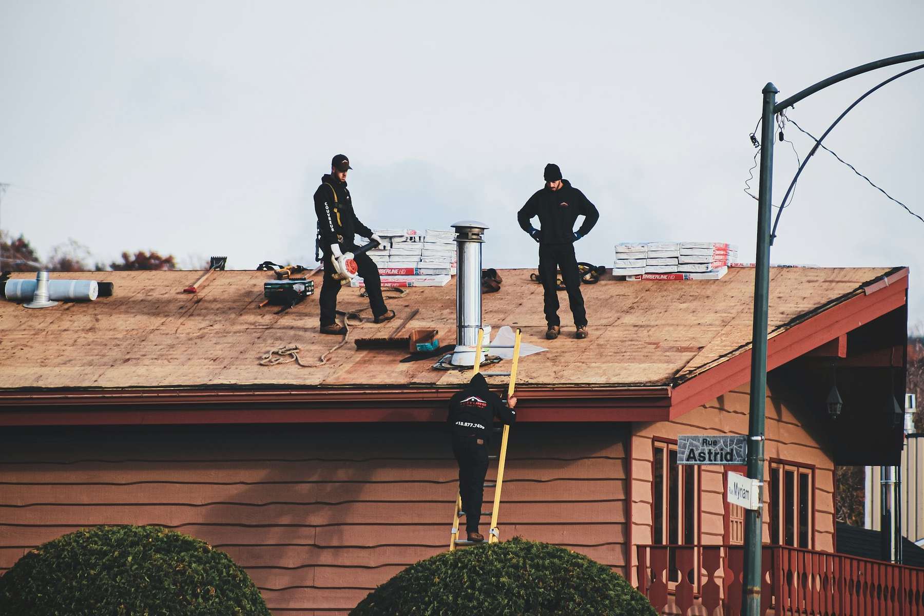 Two uniformed crew members on a job site
